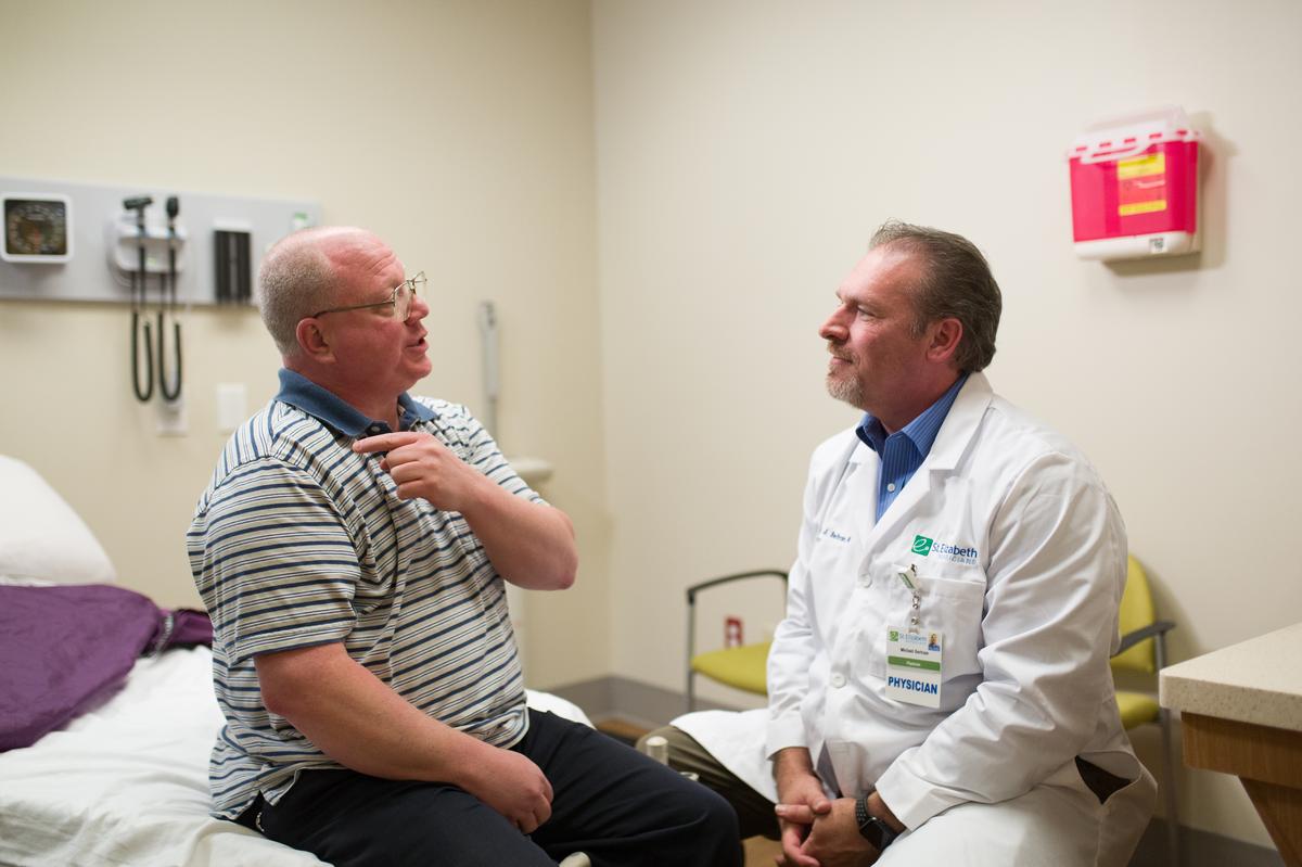 Dr. Michael Bertram speaks with a patient.
