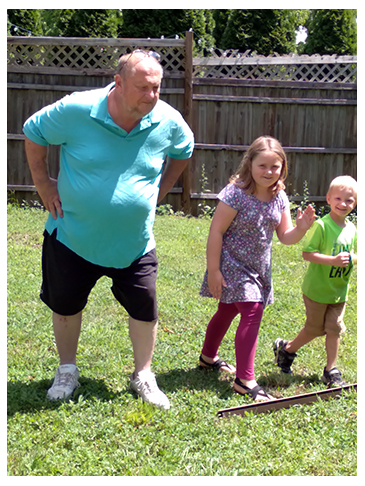 Mike Mercer with his grandchildren at play. 