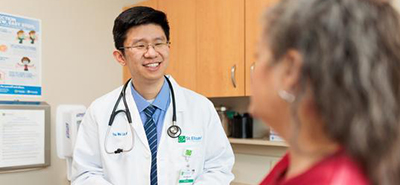 A doctor checks the lungs of a patient in a primary care office. 